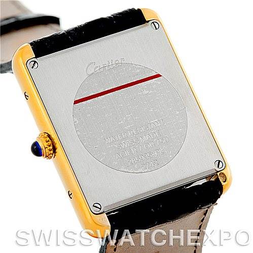 The image shows the back view of a Cartier Tank Solo W1018855 Men
s Steel and Gold (two tone) Silver Dial W1018855 Men
s Steel and Gold (two tone) Silver Dial watch with visible screws and a leather strap.
