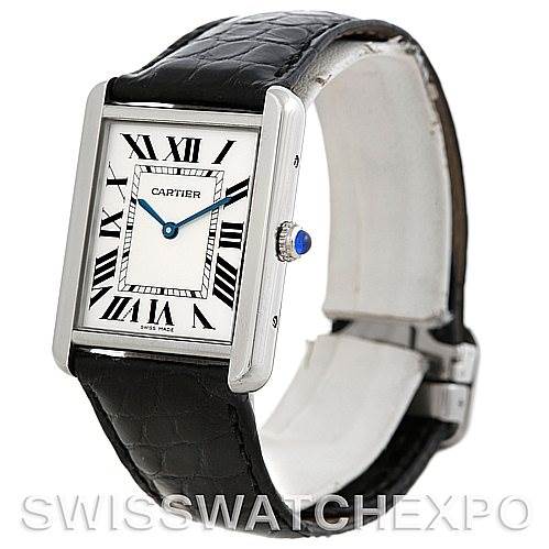 The image shows a Cartier Tank Solo W1018355 Men
s Stainless Steel Silver Dial W1018355 Men
s Stainless Steel Silver Dial watch at a three-quarter angle, highlighting its face, Roman numeral markings, rectangular case, and leather strap.