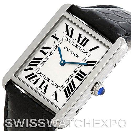 The image shows a Cartier Tank Solo W1018355 Men
s Stainless Steel Silver Dial W1018355 Men
s Stainless Steel Silver Dial watch at a slight angle, highlighting the white dial with Roman numerals, blue hands, and the crown with a blue cabochon.