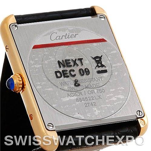 The image shows the back of a Cartier Tank Solo W1018855 Men
s Steel and Gold (two tone) Silver Dial W1018855 Men
s Steel and Gold (two tone) Silver Dial watch, highlighting the case back details and a blue sapphire crown.