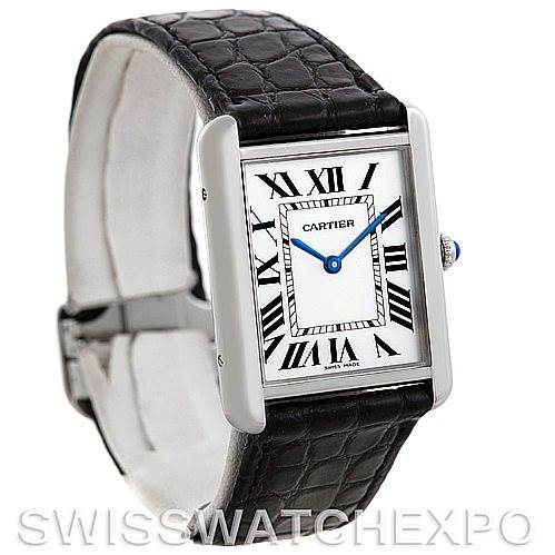 The image shows a Cartier Tank Solo W1018355 Men
s Stainless Steel Silver Dial W1018355 Men
s Stainless Steel Silver Dial watch from an angled front-left view, displaying its face, Roman numerals, blue hands, and a black leather strap.