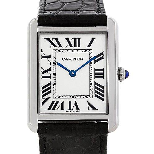 The image shows a Cartier Tank Solo W1018355 Men
s Stainless Steel Silver Dial W1018355 Men
s Stainless Steel Silver Dial watch from the front, displaying its square dial, Roman numerals, blue hands, and black leather strap.