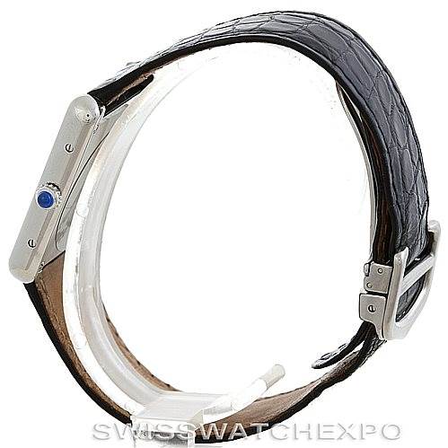 The image shows a side view of a Cartier Tank Solo W1018355 Men's Stainless Steel Silver Dial W1018355 Men's Stainless Steel Silver Dial watch, highlighting the crown with a blue cabochon, leather strap, and buckle.