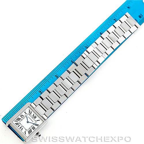 The image shows a top-down view of a Cartier Tank Solo W5200014 Men
s Stainless Steel Silver Dial W5200014 Men
s Stainless Steel Silver Dial watch, with focus on its face and metal bracelet placed next to a ruler.