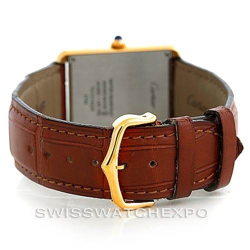 The image shows the back view of a Cartier Tank Solo W1018855 Men
s Steel and Gold (two tone) Silver Dial W1018855 Men
s Steel and Gold (two tone) Silver Dial watch, focusing on the leather strap and gold buckle.