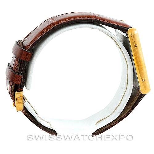 The image shows a side view of the Cartier Tank Solo W1018855 Men
s Steel and Gold (two tone) Silver Dial W1018855 Men
s Steel and Gold (two tone) Silver Dial watch, highlighting the brown leather strap and golden case.