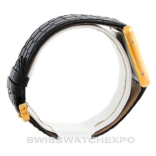 This side view image of the Cartier Tank Solo W1018855 Men
s Steel and Gold (two tone) Silver Dial W1018855 Men
s Steel and Gold (two tone) Silver Dial watch showcases the black strap and gold case.