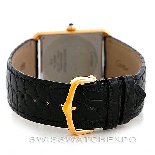 The image shows the back view of a Cartier Tank Solo W1018855 Men
s Steel and Gold (two tone) Silver Dial W1018855 Men
s Steel and Gold (two tone) Silver Dial watch, highlighting the leather strap and gold buckle.