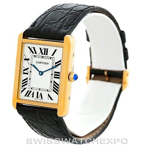 This image shows a Cartier Tank Solo W1018855 Men
s Steel and Gold (two tone) Silver Dial W1018855 Men
s Steel and Gold (two tone) Silver Dial watch at a three-quarter angle, highlighting the face, case, black leather strap, and blue gem-set winding crown.