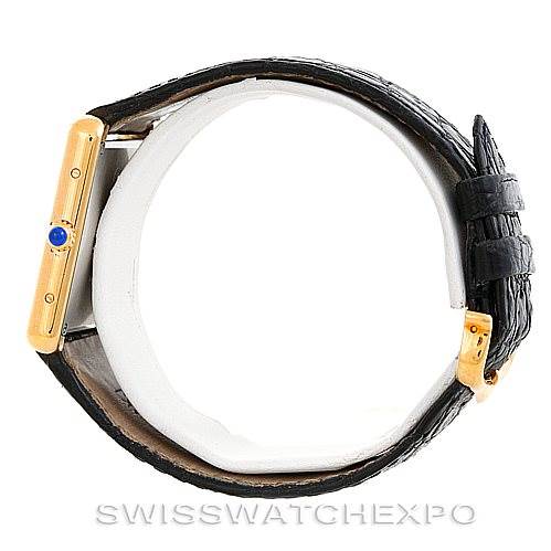 The image shows a side view of the Cartier Tank Solo W1018855 Men
s Steel and Gold (two tone) Silver Dial W1018855 Men
s Steel and Gold (two tone) Silver Dial watch, including the crown with a blue cabochon and the black leather strap.