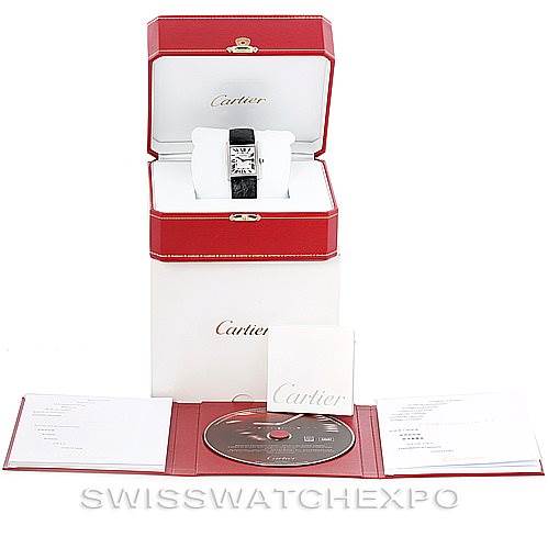 The image shows a Cartier Tank Solo W1018355 Men
s Stainless Steel Silver Dial W1018355 Men
s Stainless Steel Silver Dial watch in its case, along with its box, manual, and a CD from a frontal angle.