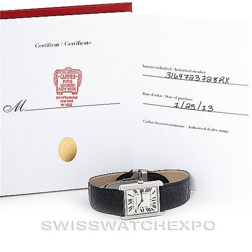 The image shows a Cartier Tank Solo W1018355 Men
s Stainless Steel Silver Dial W1018355 Men
s Stainless Steel Silver Dial watch and its certificate of Best Quality
ity, with the watch placed in front of the certificate.