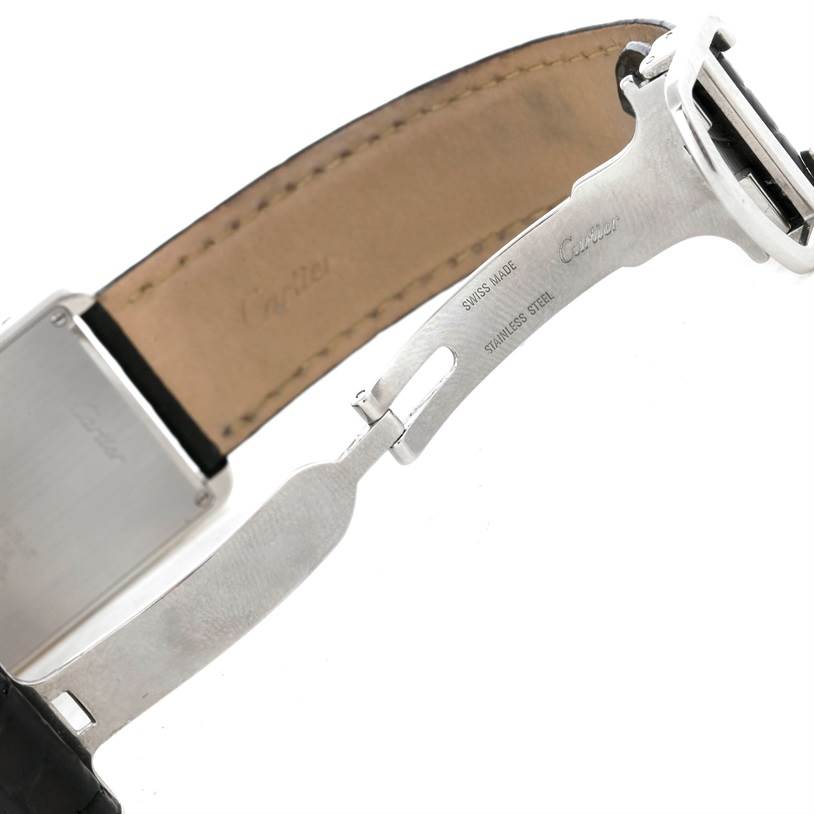 The image shows a side view of a Cartier Tank Solo W1018355 Men
s Stainless Steel Silver Dial W1018355 Men
s Stainless Steel Silver Dial watch focusing on its clasp, leather strap, and part of the stainless steel back.
