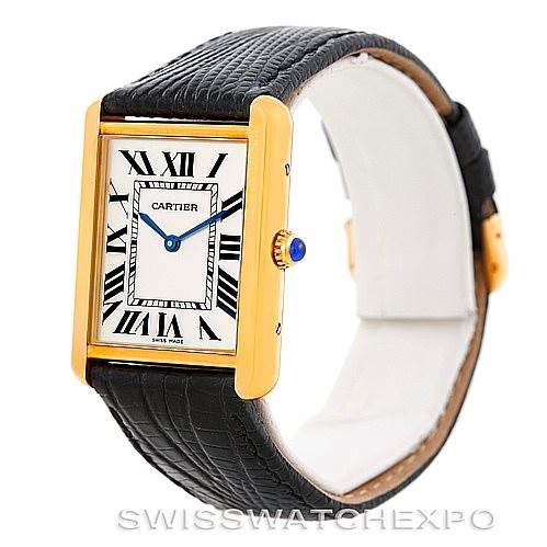 The image shows a side-angle view of the Cartier Tank Solo W1018855 Men
s Steel and Gold (two tone) Silver Dial W1018855 Men
s Steel and Gold (two tone) Silver Dial watch, highlighting its gold rectangular case, black leather strap, and blue cabochon crown.