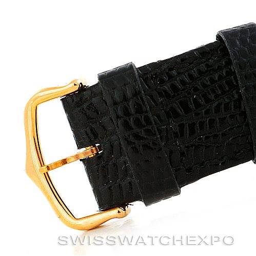 The image shows a close-up of the gold buckle and black strap of a Cartier Tank Solo W1018855 Men
s Steel and Gold (two tone) Silver Dial W1018855 Men
s Steel and Gold (two tone) Silver Dial watch.