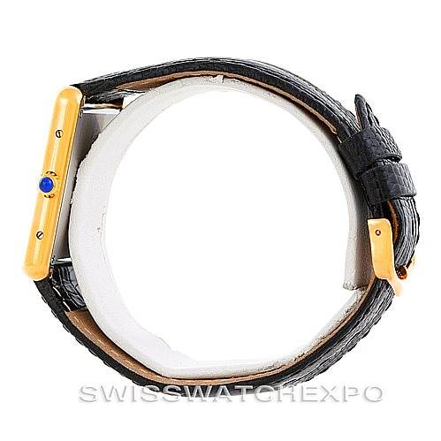 This image shows a side angle of a Cartier Tank Solo W1018855 Men
s Steel and Gold (two tone) Silver Dial W1018855 Men
s Steel and Gold (two tone) Silver Dial watch, highlighting the gold case, black leather strap, and blue sapphire crown.