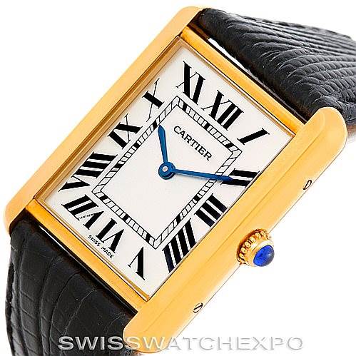 The image shows a Cartier Tank Solo W1018855 Men
s Steel and Gold (two tone) Silver Dial W1018855 Men
s Steel and Gold (two tone) Silver Dial watch at an angled view, highlighting the rectangular face, Roman numerals, gold casing, and black leather strap.