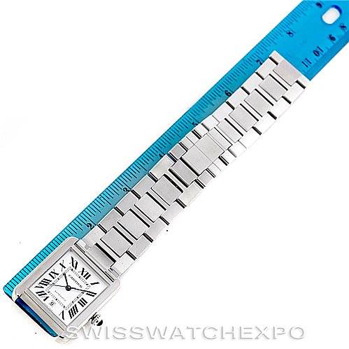 The Cartier Tank Solo W5200028 Men
s Stainless Steel Silver Dial W5200028 Men
s Stainless Steel Silver Dial watch is shown from a top view with its metal bracelet next to a blue ruler for scale.