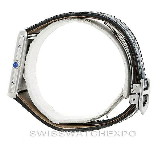 The image shows a Cartier Tank Solo W1018355 Men
s Stainless Steel Silver Dial W1018355 Men
s Stainless Steel Silver Dial model watch from a side angle, revealing the crown with a blue cabochon and part of the strap and buckle.
