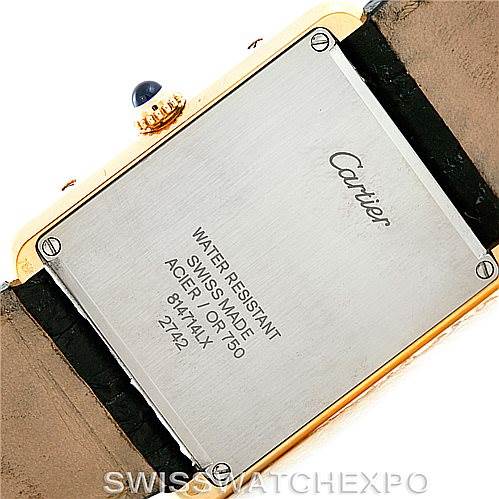 This image shows the back case of a Cartier Tank Solo W1018855 Men's Steel and Gold (two tone) Silver Dial W1018855 Men's Steel and Gold (two tone) Silver Dial watch, featuring the brand name and watch details on a gold and leather band.