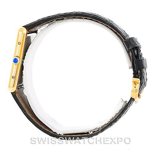 The image shows a side view of the Cartier Tank Solo W1018855 Men's Steel and Gold (two tone) Silver Dial W1018855 Men's Steel and Gold (two tone) Silver Dial watch, highlighting its gold case, blue cabochon crown, and black leather strap.