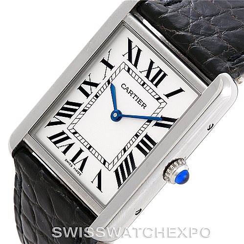 This image shows a Cartier Tank Solo W1018355 Men's Stainless Steel Silver Dial W1018355 Men's Stainless Steel Silver Dial watch at an angled view, displaying its face, Roman numerals, blue hands, and leather strap.