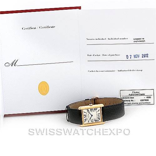 The image shows a Cartier Tank Solo W1018855 Men's Steel and Gold (two tone) Silver Dial W1018855 Men's Steel and Gold (two tone) Silver Dial watch with its certificate and warranty card, viewed from the front with the watch laying flat.