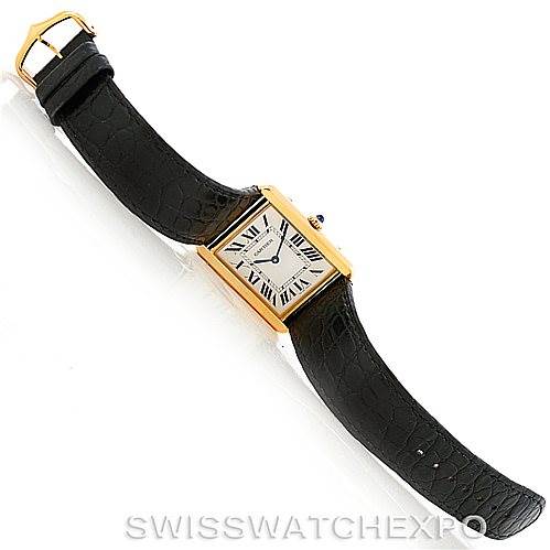 The image shows a top-down view of the Cartier Tank Solo W1018855 Men's Steel and Gold (two tone) Silver Dial W1018855 Men's Steel and Gold (two tone) Silver Dial watch with a black leather strap and gold rectangular case.