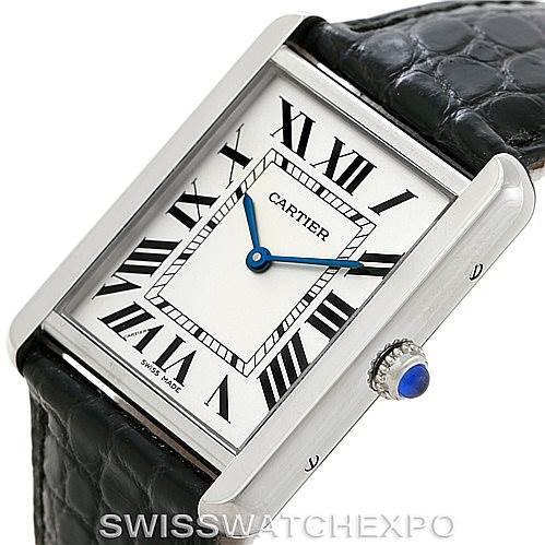 The image shows a Cartier Tank Solo W1018355 Men
s Stainless Steel Silver Dial W1018355 Men
s Stainless Steel Silver Dial watch face and part of the leather strap at an angled view.