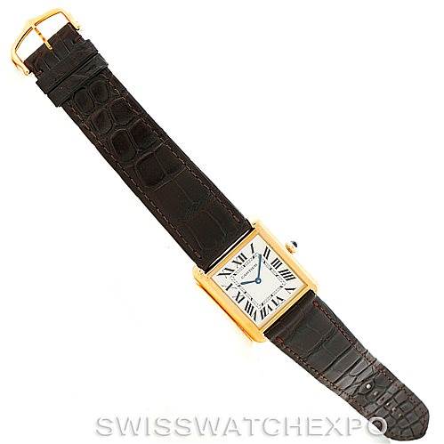 The image shows a top view of a Cartier Tank Solo W1018855 Men
s Steel and Gold (two tone) Silver Dial W1018855 Men
s Steel and Gold (two tone) Silver Dial watch, featuring a gold rectangular case and a brown leather strap with a deployant buckle.