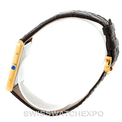 The image shows a Cartier Tank Solo W1018855 Men
s Steel and Gold (two tone) Silver Dial W1018855 Men
s Steel and Gold (two tone) Silver Dial watch from a side angle, displaying the crown and a portion of the leather strap.