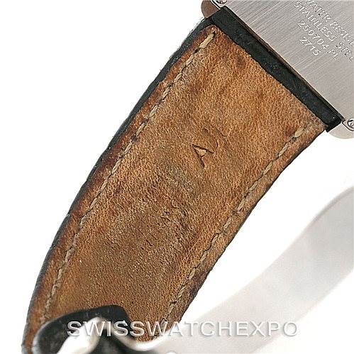 The image shows the back of a Cartier Tank Solo W1018355 Men
s Stainless Steel Silver Dial W1018355 Men
s Stainless Steel Silver Dial watch and its leather strap attachment.