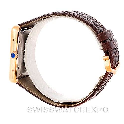 The image shows the side view of a Cartier Tank Solo W5200026 Men
s Steel and Gold (two tone) Silver Dial W5200026 Men
s Steel and Gold (two tone) Silver Dial watch, highlighting the crown and leather strap.