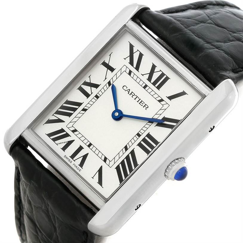 The image shows a Cartier Tank Solo W1018355 Men
s Stainless Steel Silver Dial W1018355 Men
s Stainless Steel Silver Dial watch at an angle highlighting the face, Roman numerals, blue hands, and part of the black leather strap.