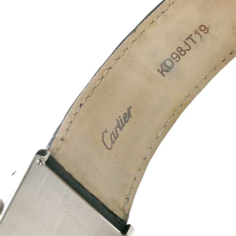 The image shows a close-up angle of the leather strap and stainless steel casing of a Cartier Tank Solo W1018355 Men
s Stainless Steel Silver Dial W1018355 Men
s Stainless Steel Silver Dial watch, with part of the brand name visible on the strap.