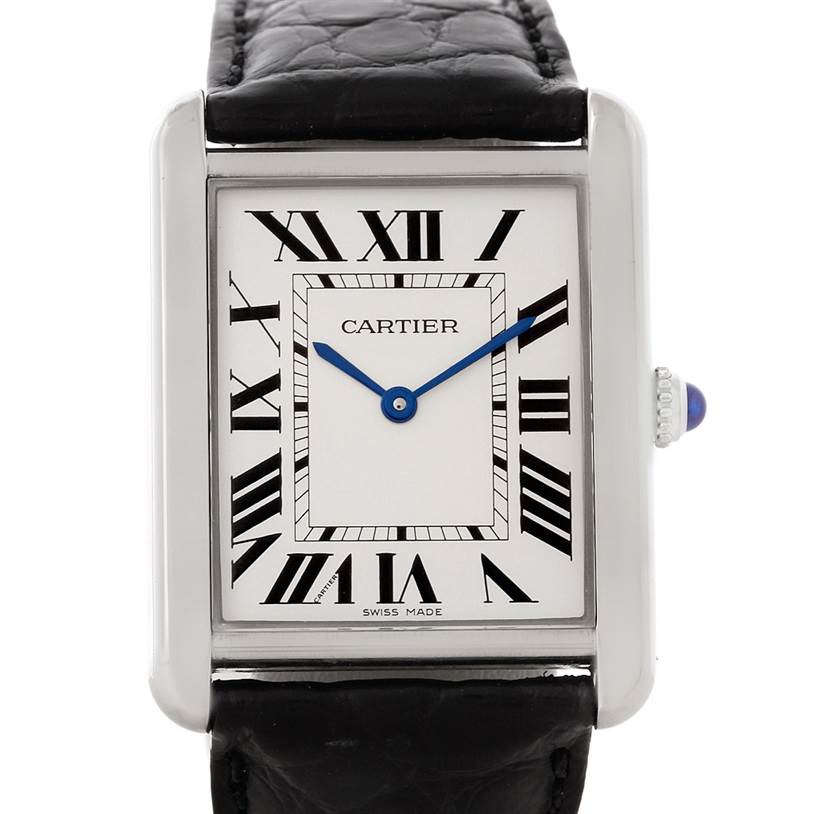 The image shows a Cartier Tank Solo W1018355 Men
s Stainless Steel Silver Dial W1018355 Men
s Stainless Steel Silver Dial watch face from a front angle, featuring a rectangular case, Roman numeral indices, and a black leather strap.