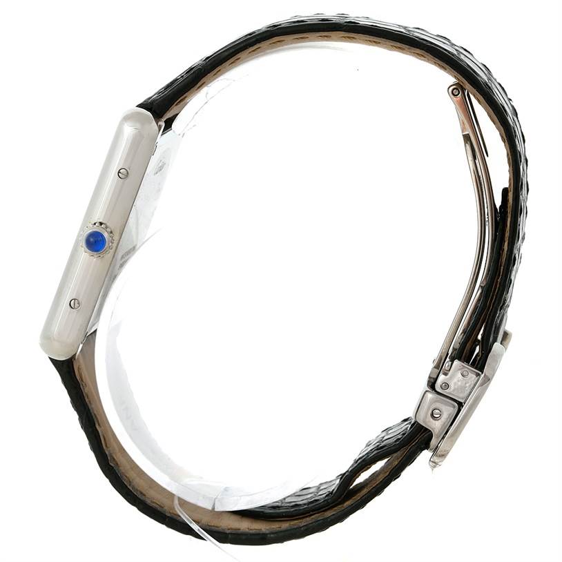 This side view of the Cartier Tank Solo W1018355 Men
s Stainless Steel Silver Dial W1018355 Men
s Stainless Steel Silver Dial watch shows the case, crown with blue gem, strap, and buckle.