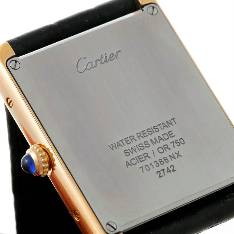 This image shows the back case and crown of a Cartier Tank Solo W1018855 Men
s Steel and Gold (two tone) Silver Dial W1018855 Men
s Steel and Gold (two tone) Silver Dial watch, emphasizing its engraving and water resistance information.