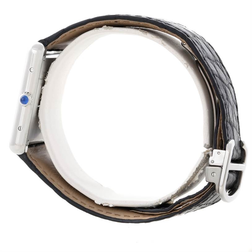 The image shows a side profile view of the Cartier Tank Solo W1018355 Men
s Stainless Steel Silver Dial W1018355 Men
s Stainless Steel Silver Dial watch, highlighting the case, crown, and a part of the leather strap with its buckle.