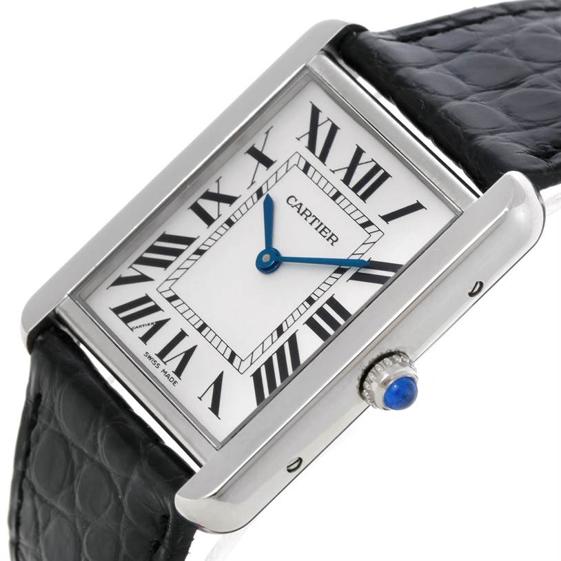 The image shows a close-up, slightly angled view of the Cartier Tank Solo W1018355 Men's Stainless Steel Silver Dial W1018355 Men's Stainless Steel Silver Dial watch, displaying its dial, Roman numerals, blue hands, and black leather strap.