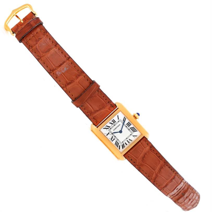 The image shows a top view of a Cartier Tank Solo W1018755 Women's Steel and Gold (two tone) Silver Dial W1018755 Women's Steel and Gold (two tone) Silver Dial watch with a brown leather strap and gold rectangular case.