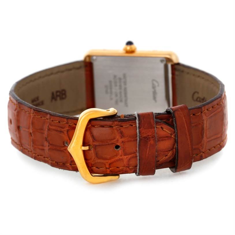 This image shows the back of a Cartier Tank Solo W1018755 Women's Steel and Gold (two tone) Silver Dial W1018755 Women's Steel and Gold (two tone) Silver Dial watch, highlighting its brown leather strap and gold buckle.