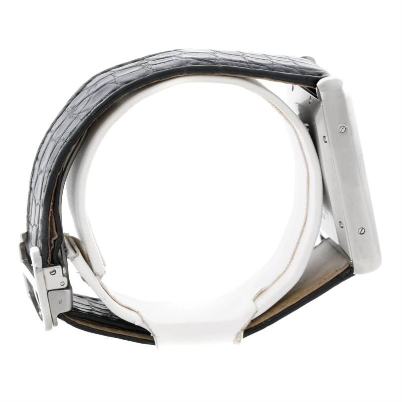 The side angle shows the black leather strap and metal casing of the Tank Solo model by Cartier.