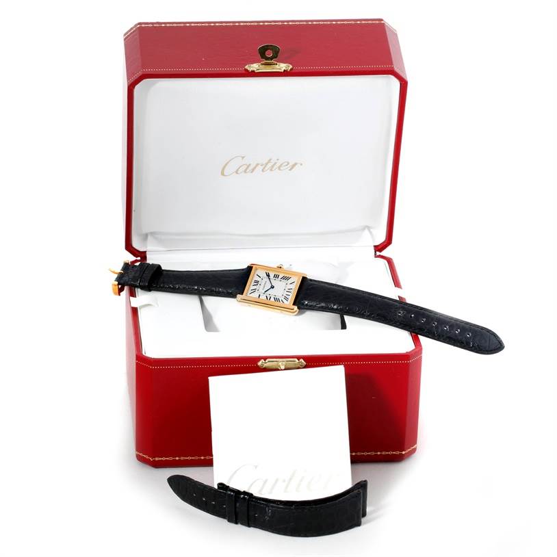 A Cartier Tank Solo W1018855 Men
s Steel and Gold (two tone) Silver Dial W1018855 Men
s Steel and Gold (two tone) Silver Dial watch is shown face-up in its open red box, along with an extra black leather strap.