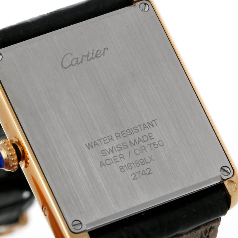 This image shows the back case of the Cartier Tank Solo W1018855 Men
s Steel and Gold (two tone) Silver Dial W1018855 Men
s Steel and Gold (two tone) Silver Dial watch, highlighting the inscription and screws.