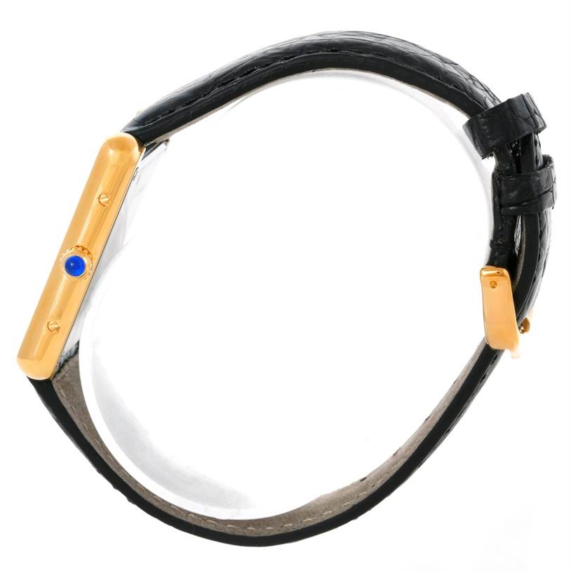 The image shows a side profile of the Cartier Tank Solo W1018855 Men
s Steel and Gold (two tone) Silver Dial W1018855 Men
s Steel and Gold (two tone) Silver Dial watch, highlighting its bezel, crown, and black leather strap.