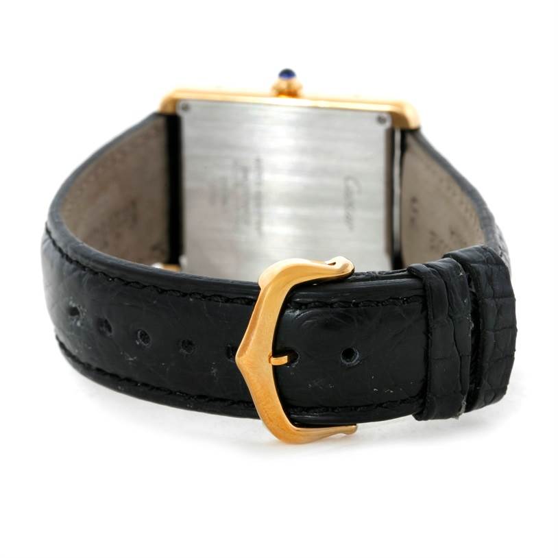 The image shows the back of a Cartier Tank Solo W1018855 Men
s Steel and Gold (two tone) Silver Dial W1018855 Men
s Steel and Gold (two tone) Silver Dial watch, highlighting the clasp and black leather strap.