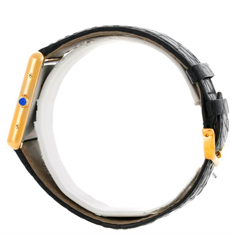 The Cartier Tank Solo W1018855 Men
s Steel and Gold (two tone) Silver Dial W1018855 Men
s Steel and Gold (two tone) Silver Dial watch is shown from a side angle, highlighting its strap, buckle, and crown.