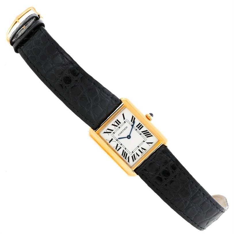 The Cartier Tank Solo W1018855 Men
s Steel and Gold (two tone) Silver Dial W1018855 Men
s Steel and Gold (two tone) Silver Dial watch is shown at an angled top view, displaying the dial, gold case, and black leather strap.