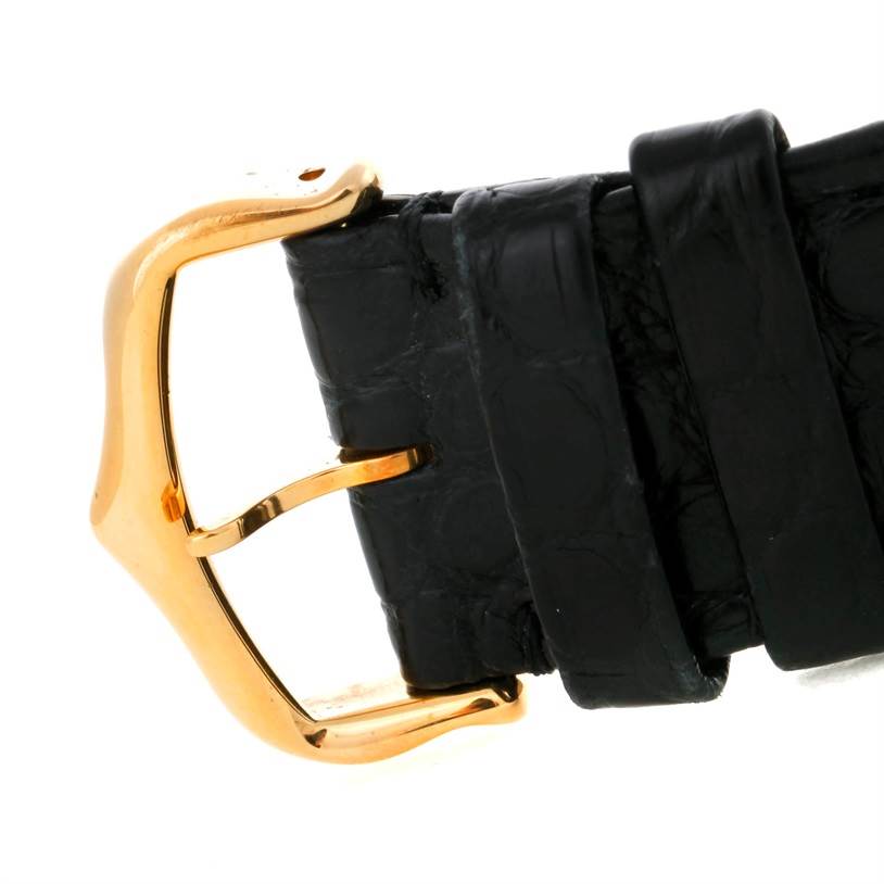 This image shows a close-up of the black leather strap and gold buckle of a Cartier Tank Solo W1018855 Men
s Steel and Gold (two tone) Silver Dial W1018855 Men
s Steel and Gold (two tone) Silver Dial watch.